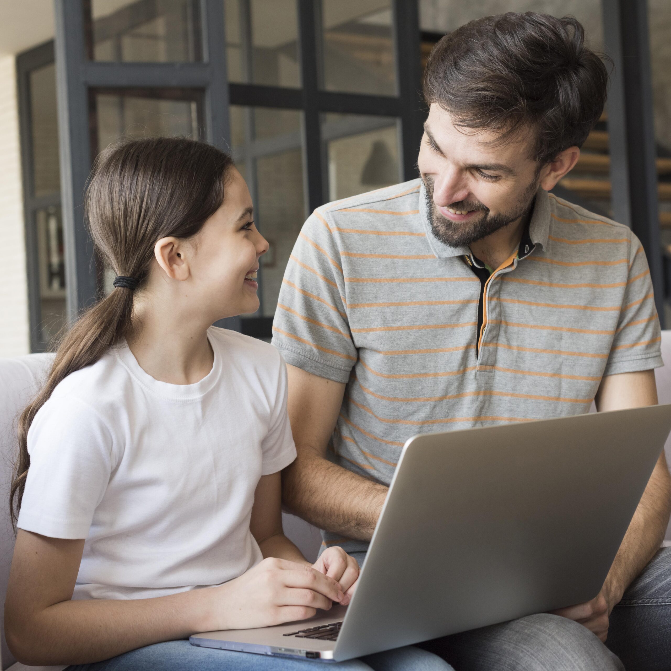 smiley girl dad with laptop scaled