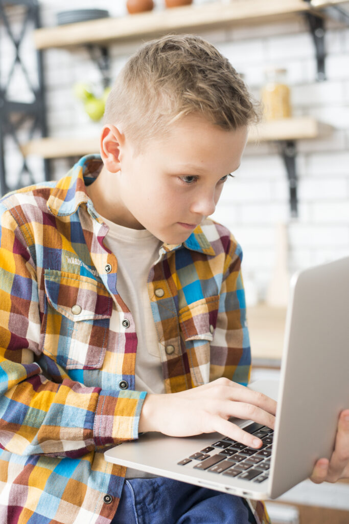 boy with laptop kitchen